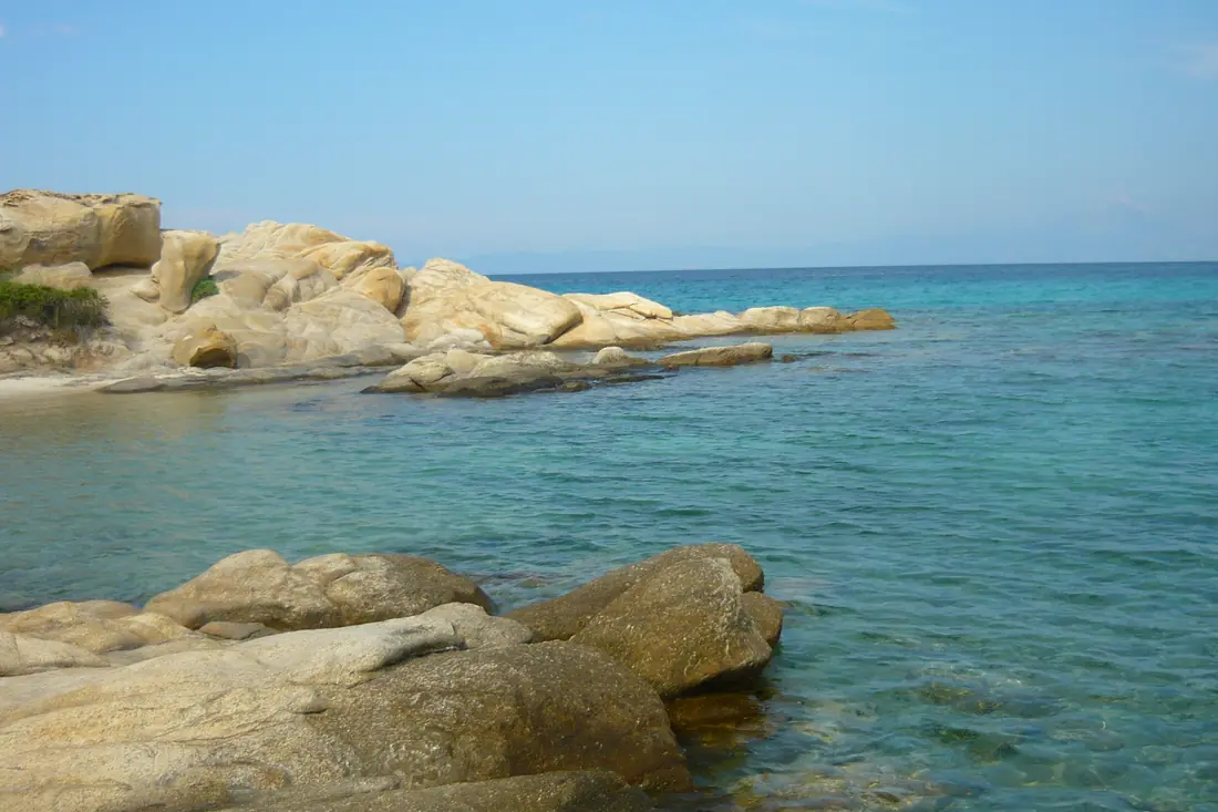 Large rounded granite boulders in the shallow turquoise water at Karydi near Vourvourou